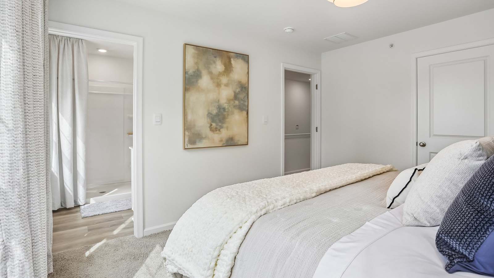 Primary bedroom with a peek into the hallway