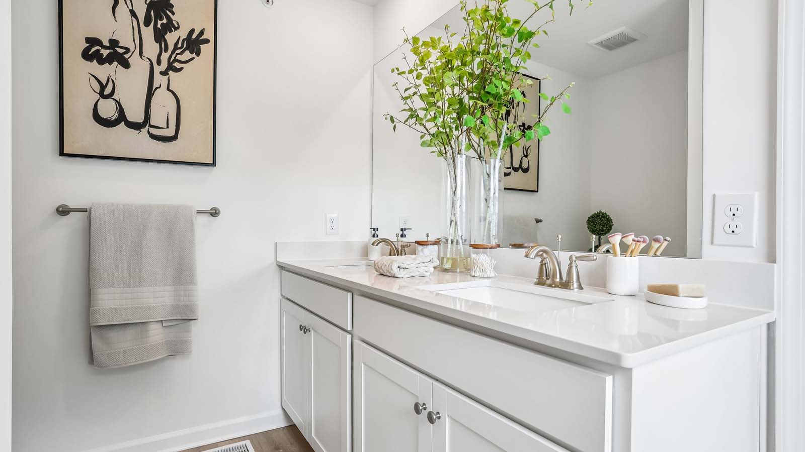 Primary bathroom with double bowl vanity, and white cabinets