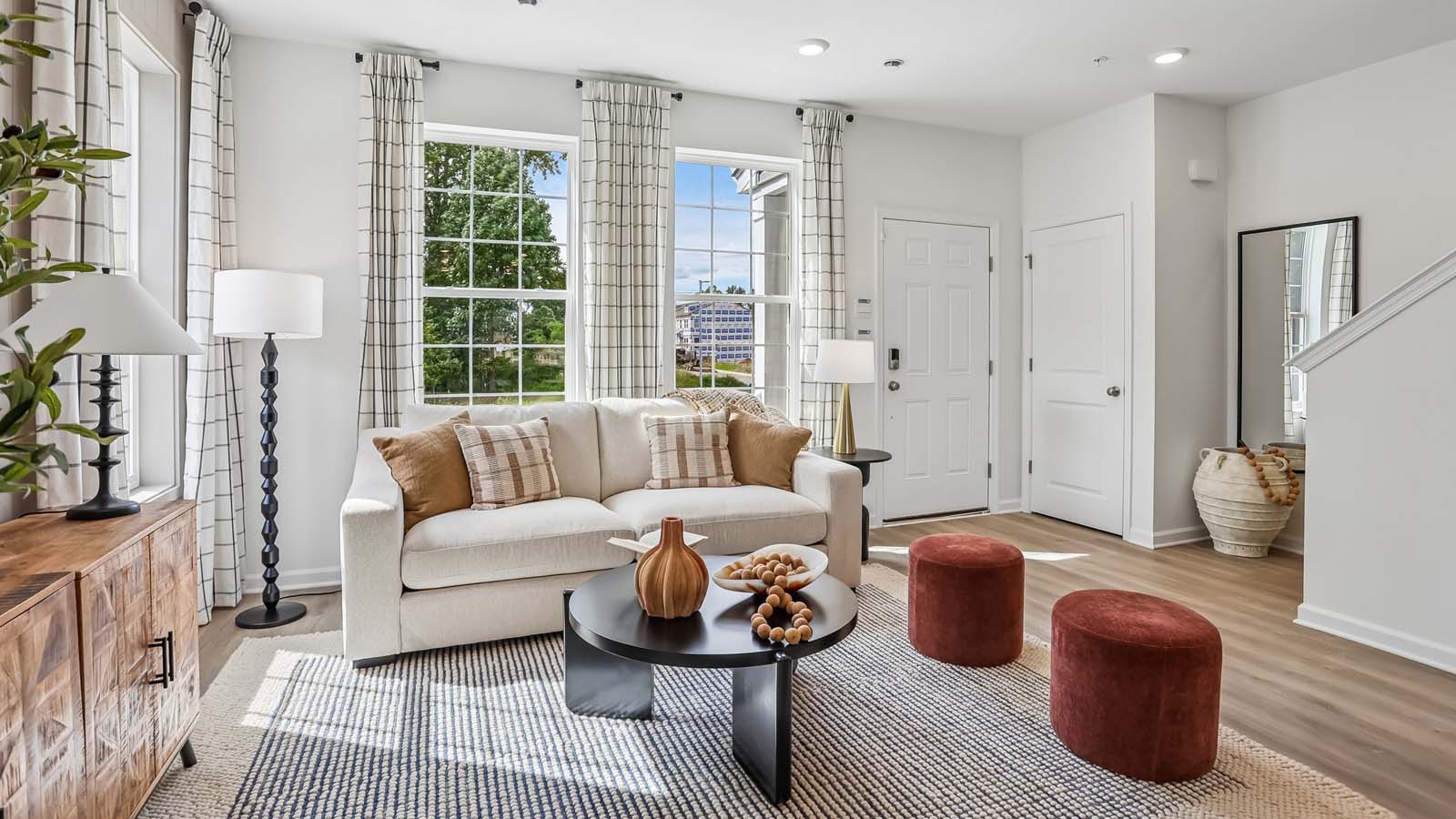 Living room and a view of the coat closet and stairwell to bedroom level