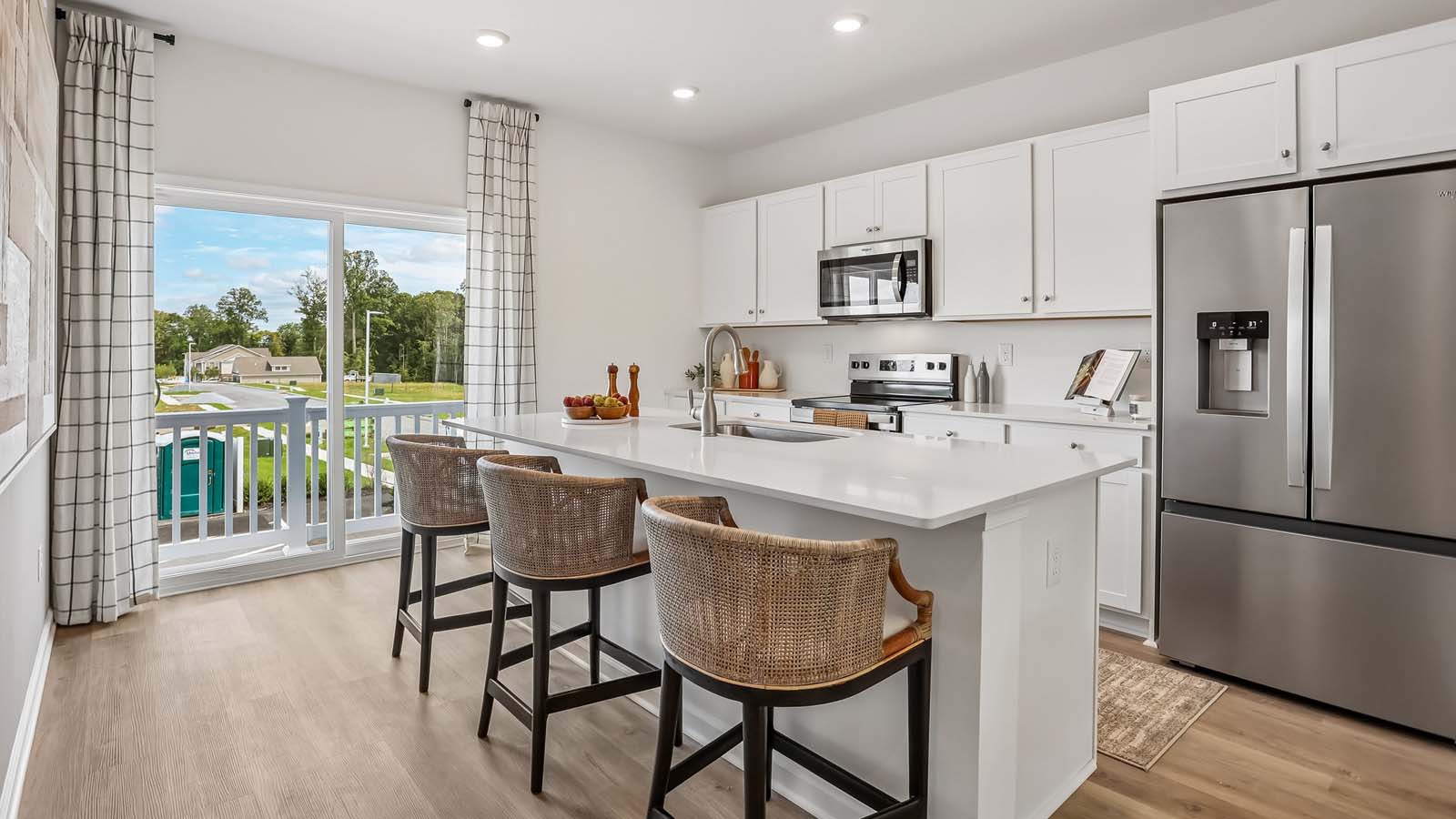 Kitchen area with sliding glass door and small deck on the back