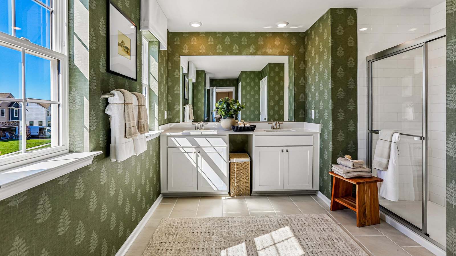 The owner's suite bathroom with double vanity and walk-in shower.