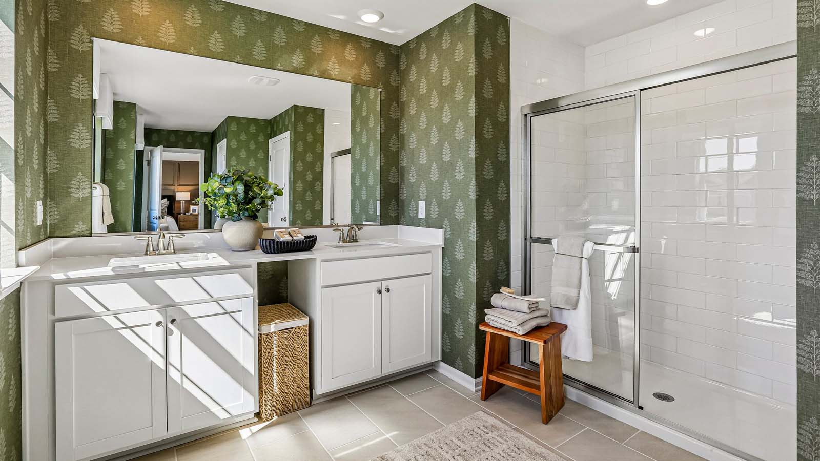 The owner's suite bathroom with double vanity and walk-in shower.