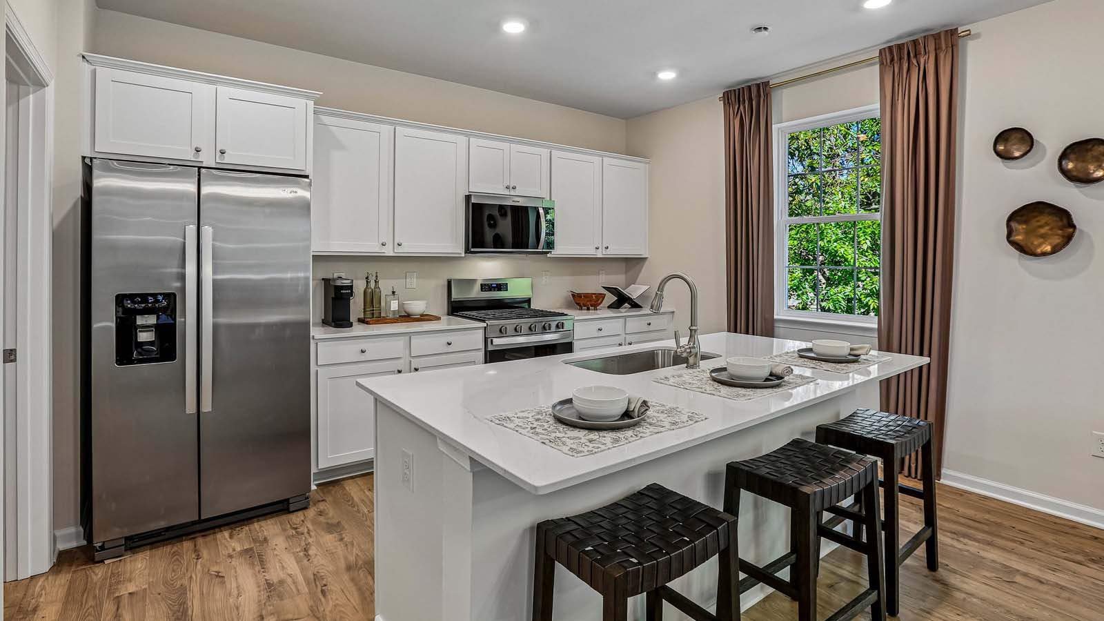 The kitchen island features a single sink.