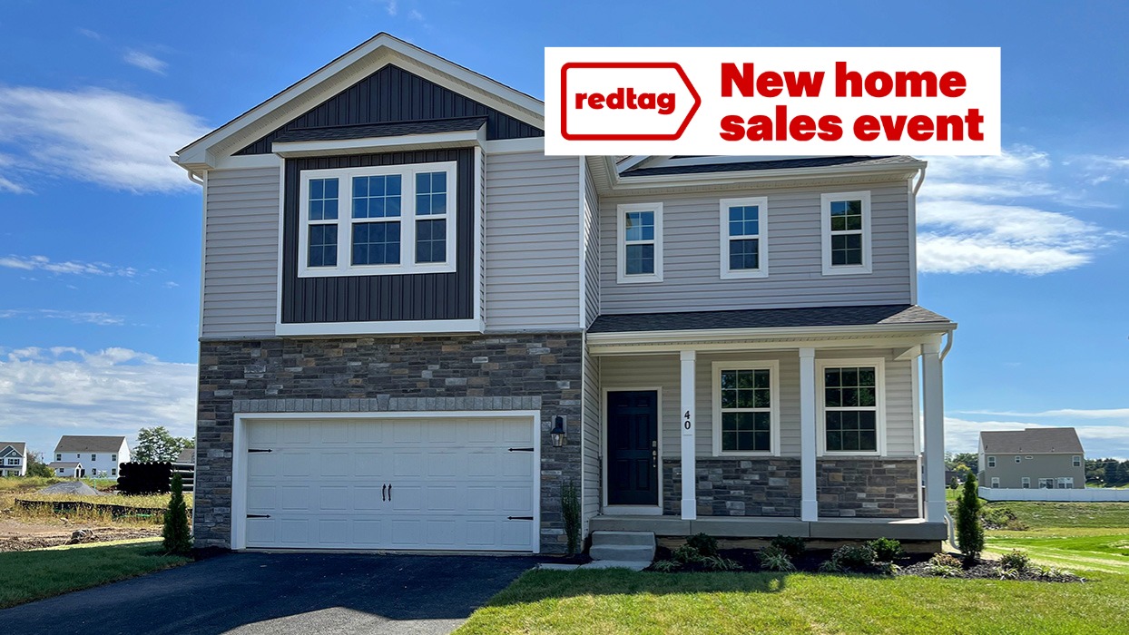 A two-story Galen home with wicker siding, midnight surf board and batten accent siding, and champagne ledgestone surrounding a white two car garage.