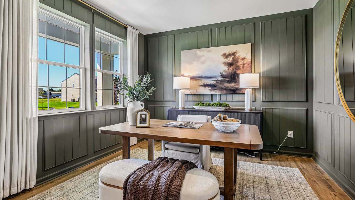 The flex room features high ceilings and two windows.