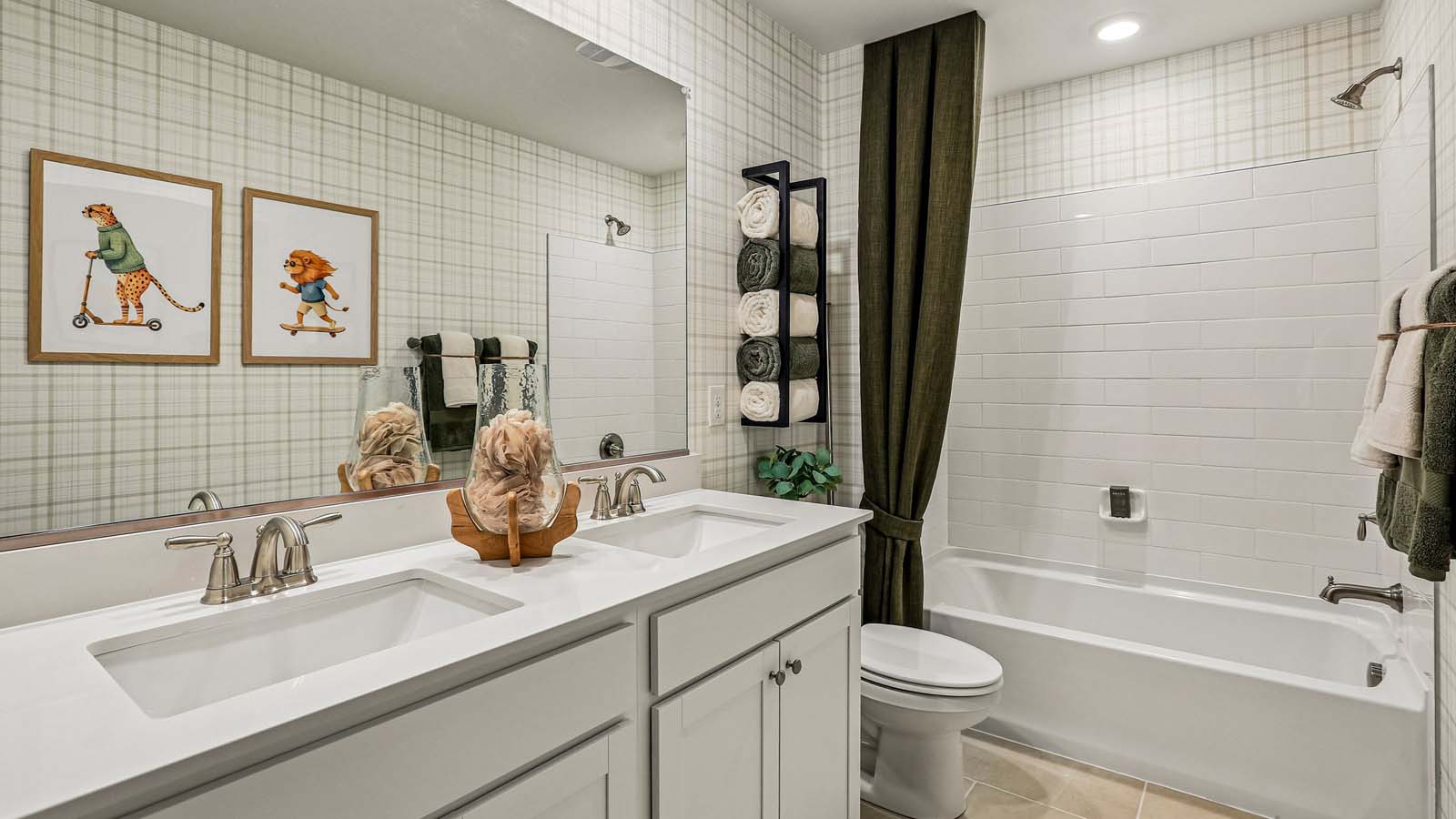 A spacious hall bathroom with double vanity and shower.