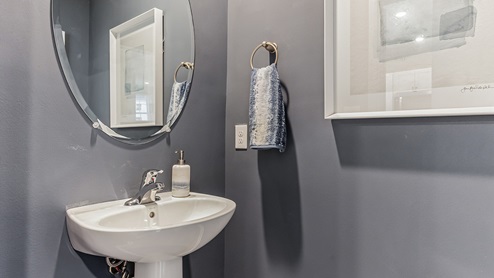 Half bath with single sink on the first floor.