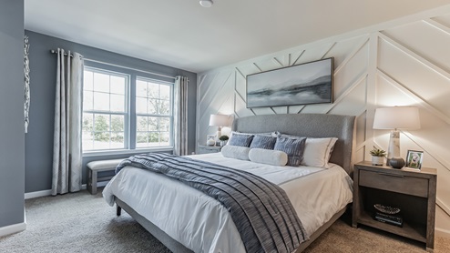 Primary bedroom with large double window.