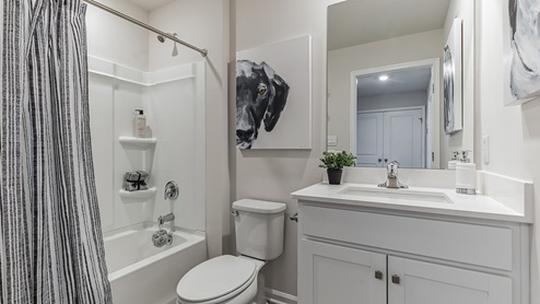 Full bath with single sink counter and vanity and bathtub.
