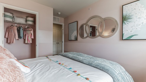Third bedroom upstairs girly themed with view of the closet.