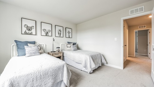 Upstairs bedroom with two twin beds in it.
