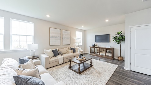 Different view of the living area standing near the stairs.
