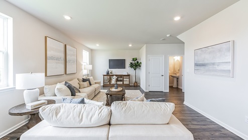 Spacious living area with extra storage closet and half bath.