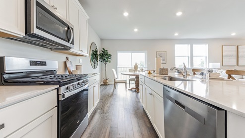 The walkway between the wall of the kitchen and the island looking towards the dining area..