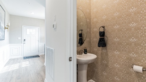 Half bath with single sink on the first floor.