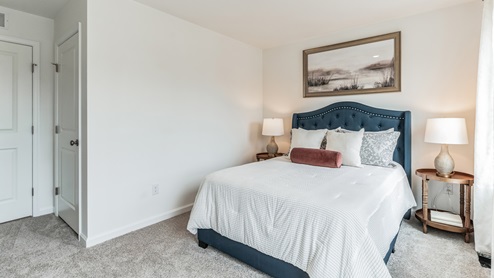 Bedroom four is decorated as an office space with view of a single window.