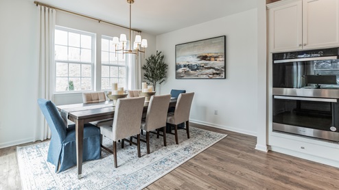 Angled view of the dining area with the large double window in the back.