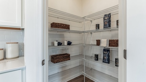 Large pantry area with several levels of shelves.