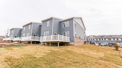 Exterior back image of the townhomes with back balcony.