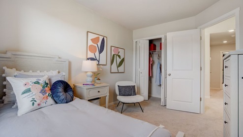 Child’s bedroom with wall-to-wall carpet and a closet