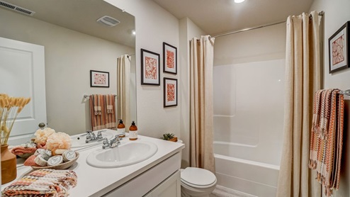 bathroom with quartz countertops, combination show/bathtub, ad white toilet