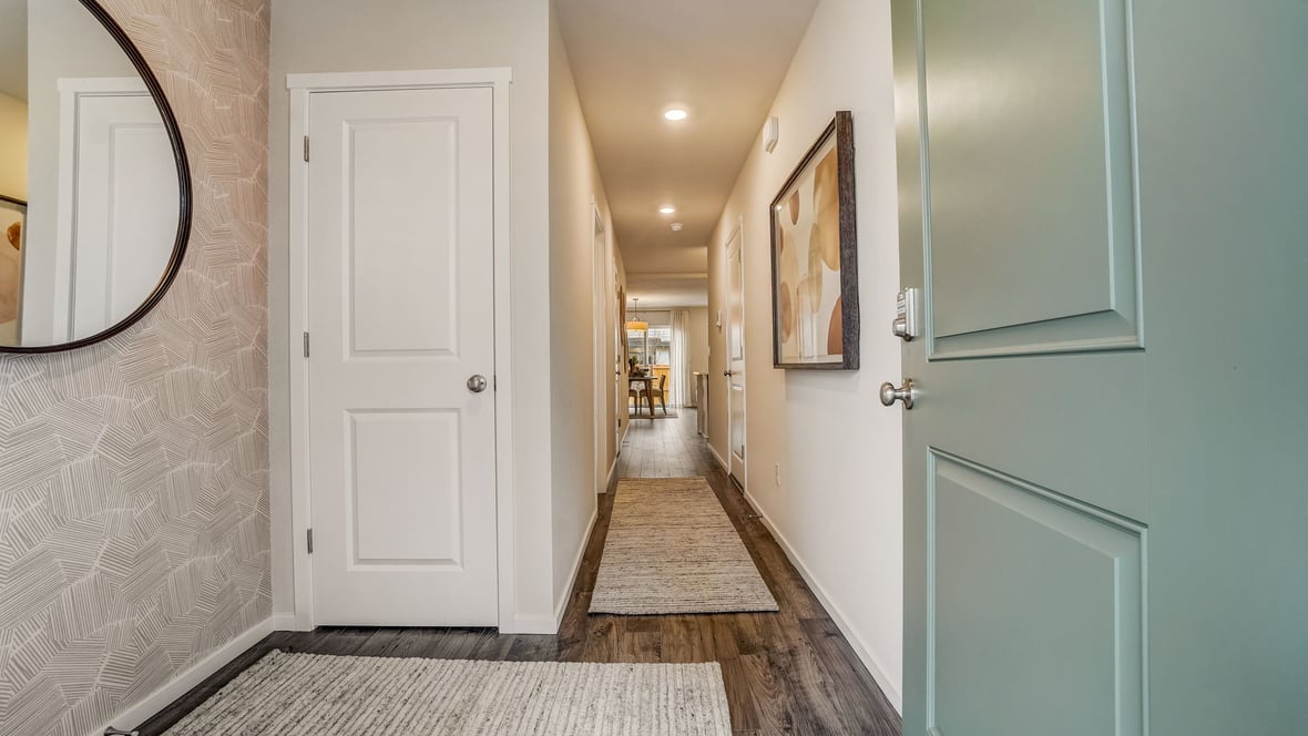 Entryway with a coat closet and laminate flooring