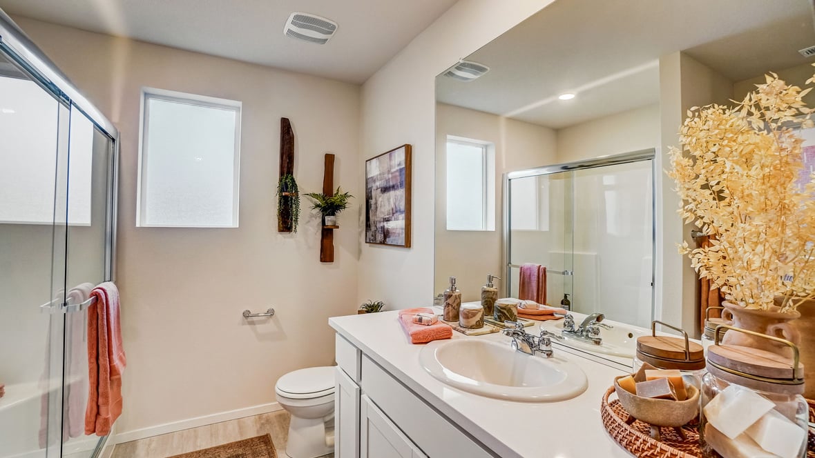 Primary bathroom with quartz counters and a walk-in shower