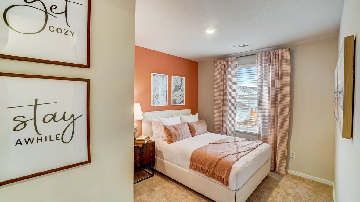 Guest bedroom with wall-to-wall carpet and a closet