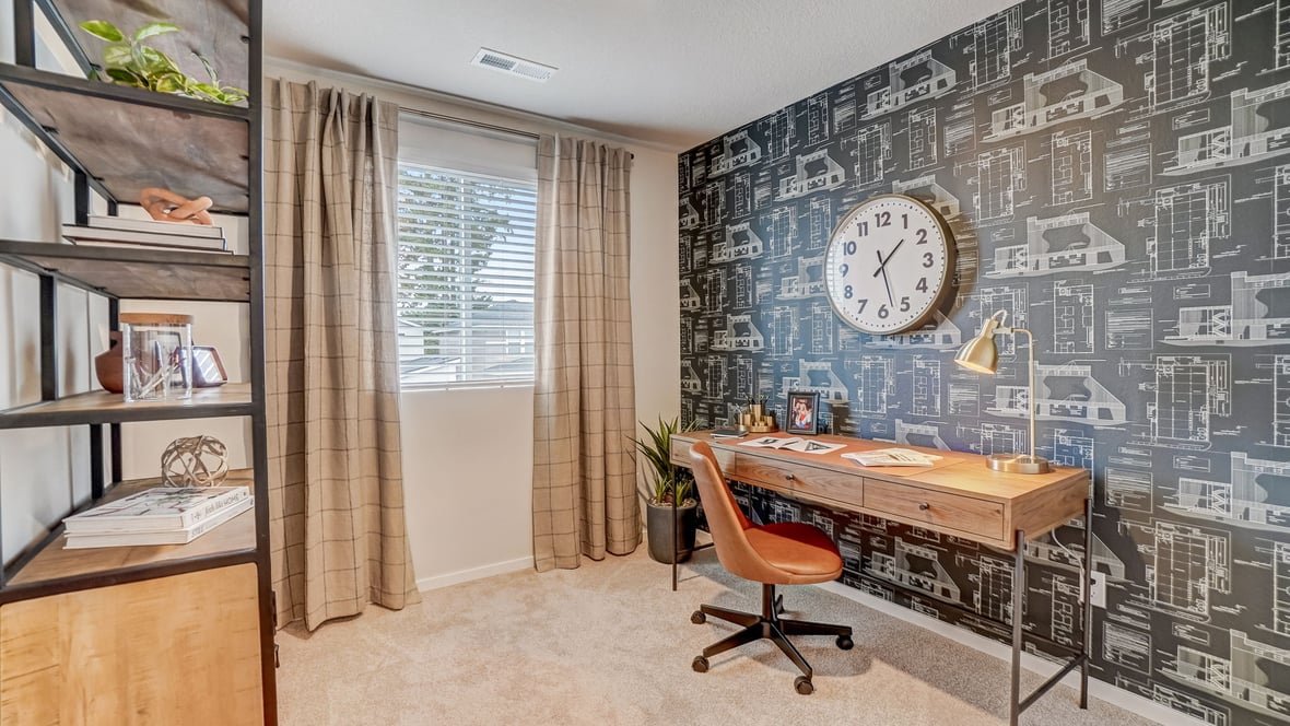 Bedroom staged as an office with wall-to-wall carpet and a closet
