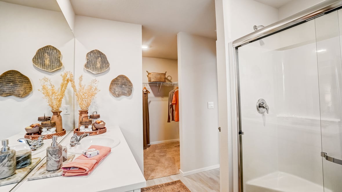 Primary bathroom with quartz counters and a walk-in shower