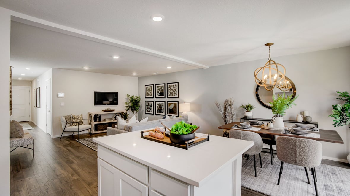 Kitchen with shaker cabinets, quartz counters, stainless steel appliances, pantry, and an island with a breakfast bar