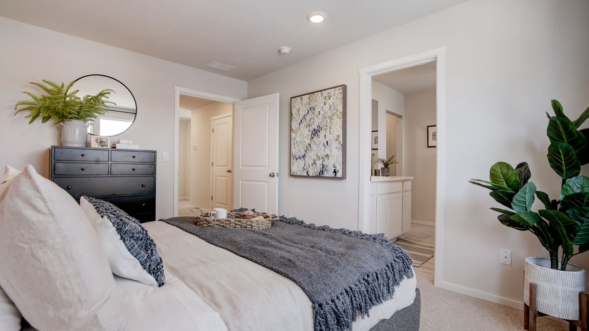 Primary bedroom with wall-to-wall carpet, a walk-in closet and an attached bathroom