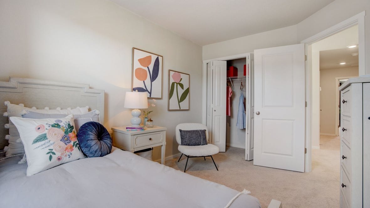 Bedroom with wall-to-wall carpet and a closet
