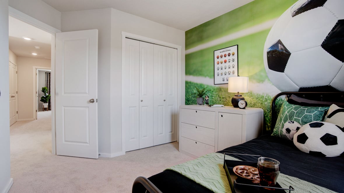 Bedroom with wall-to-wall carpet and a closet