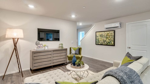 open-concept living room. Premium laminate flooring and a closet under the stairs
