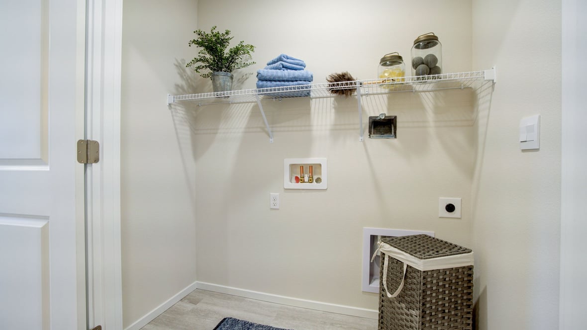 Laundry closet with wire shelves and washer and dryer hookups
