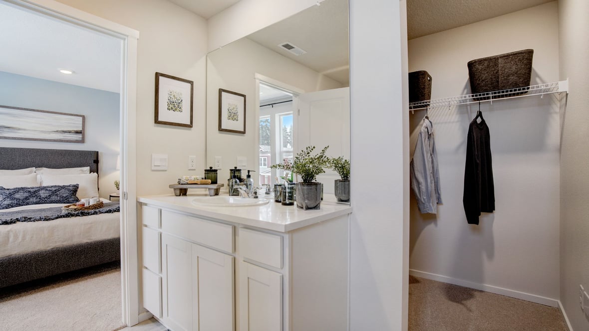 Primary bathroom with quartz counters and a walk-in shower