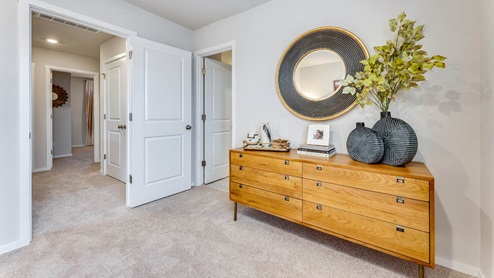 primary bedroom with a walk-in closet, en suite bathroom, and wall-to-wall carpet