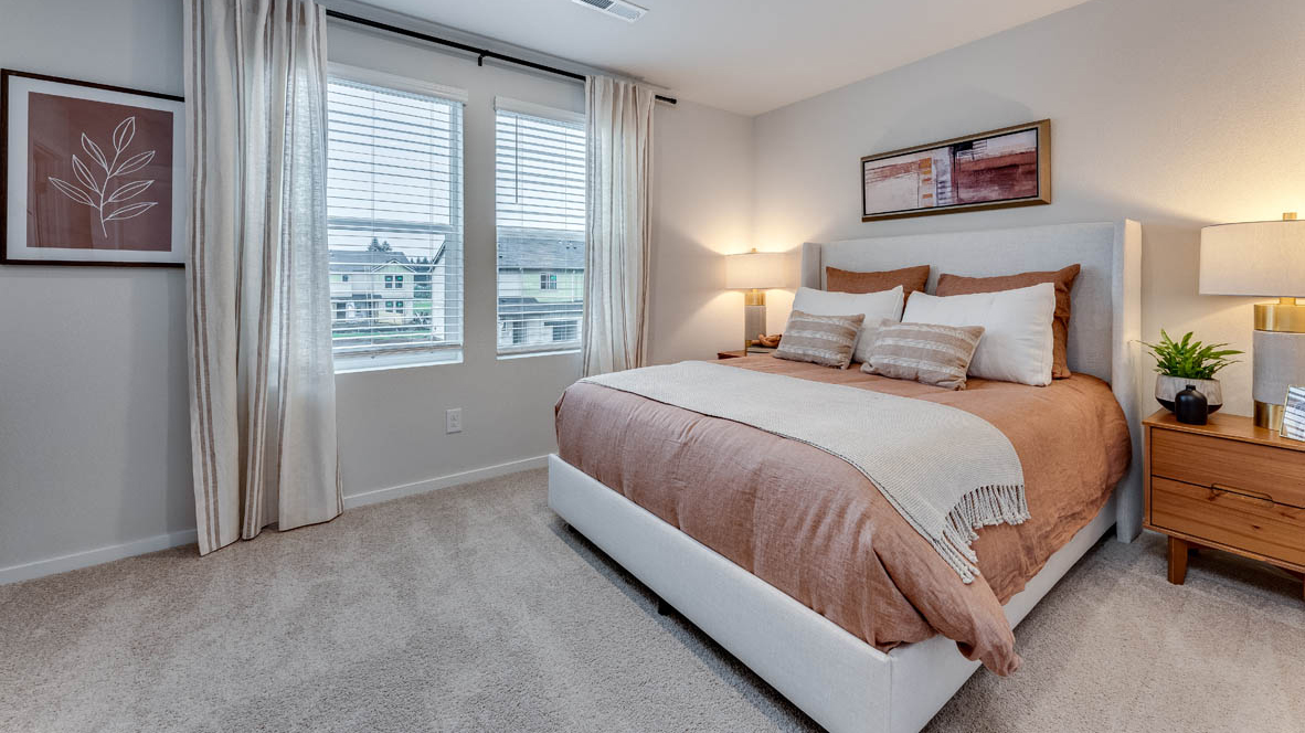 Primary bedroom with wall-to-wall carpet, a walk-in closet and an attached bathroom