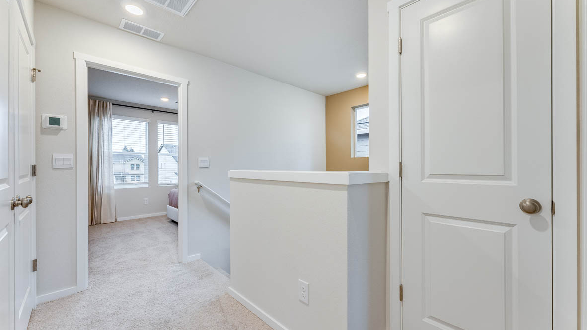 Hallway with wall-to-wall carpet