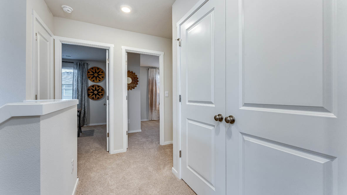 Hallway with wall-to-wall carpet