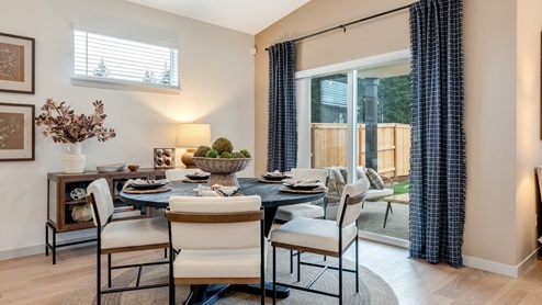 Dining area with a sliding glass door to a fenced backyard