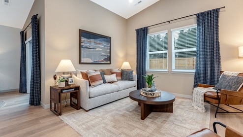 Great room with laminate flooring and an electric fireplace and vaulted ceilings