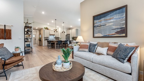 Great room with laminate flooring and an electric fireplace and vaulted ceilings