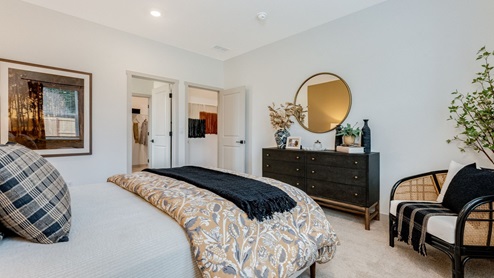 Primary bedroom with wall-to-wall carpet, a walk-in closet and an attached bathroom