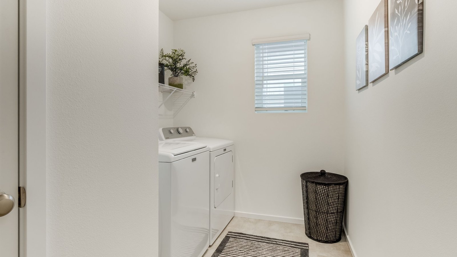 Laundry room with wire shelves and washer and dryer hookups