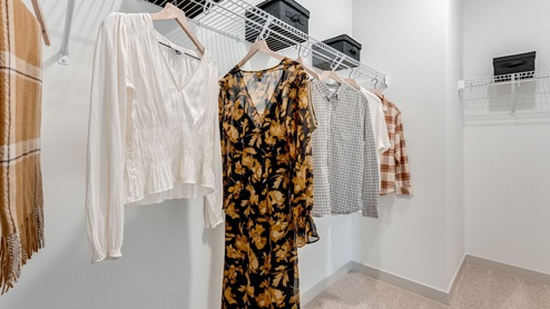 Primary bedroom walk-in closet with wire shelves