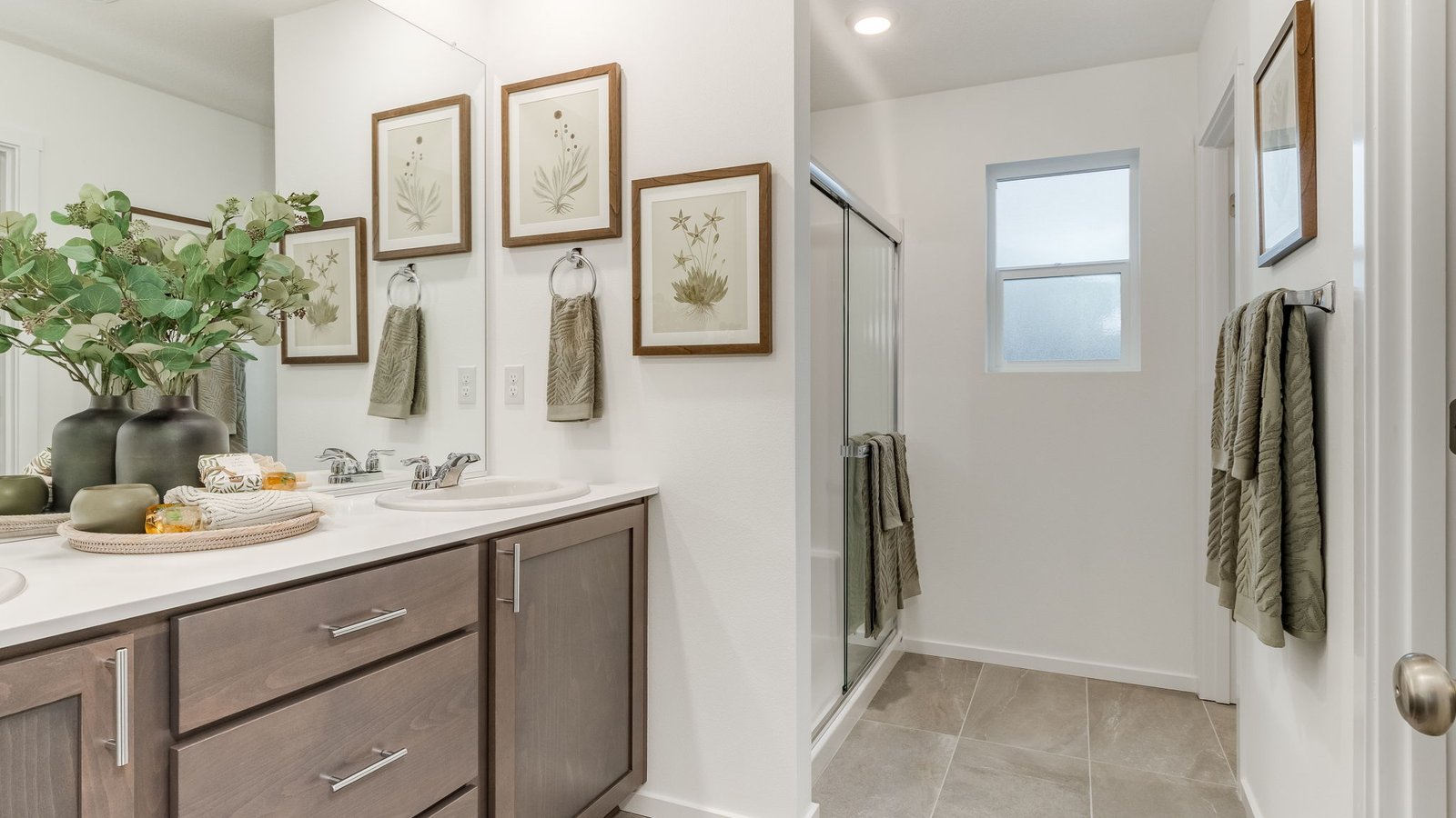 Primary bathroom with quartz counters and a walk-in shower