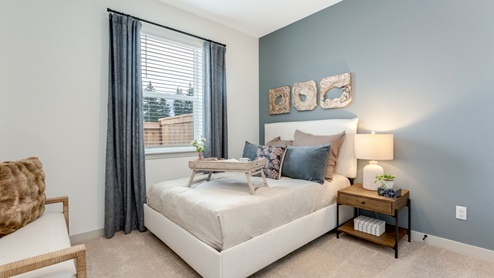 Guest bedroom with wall-to-wall carpet and a closet