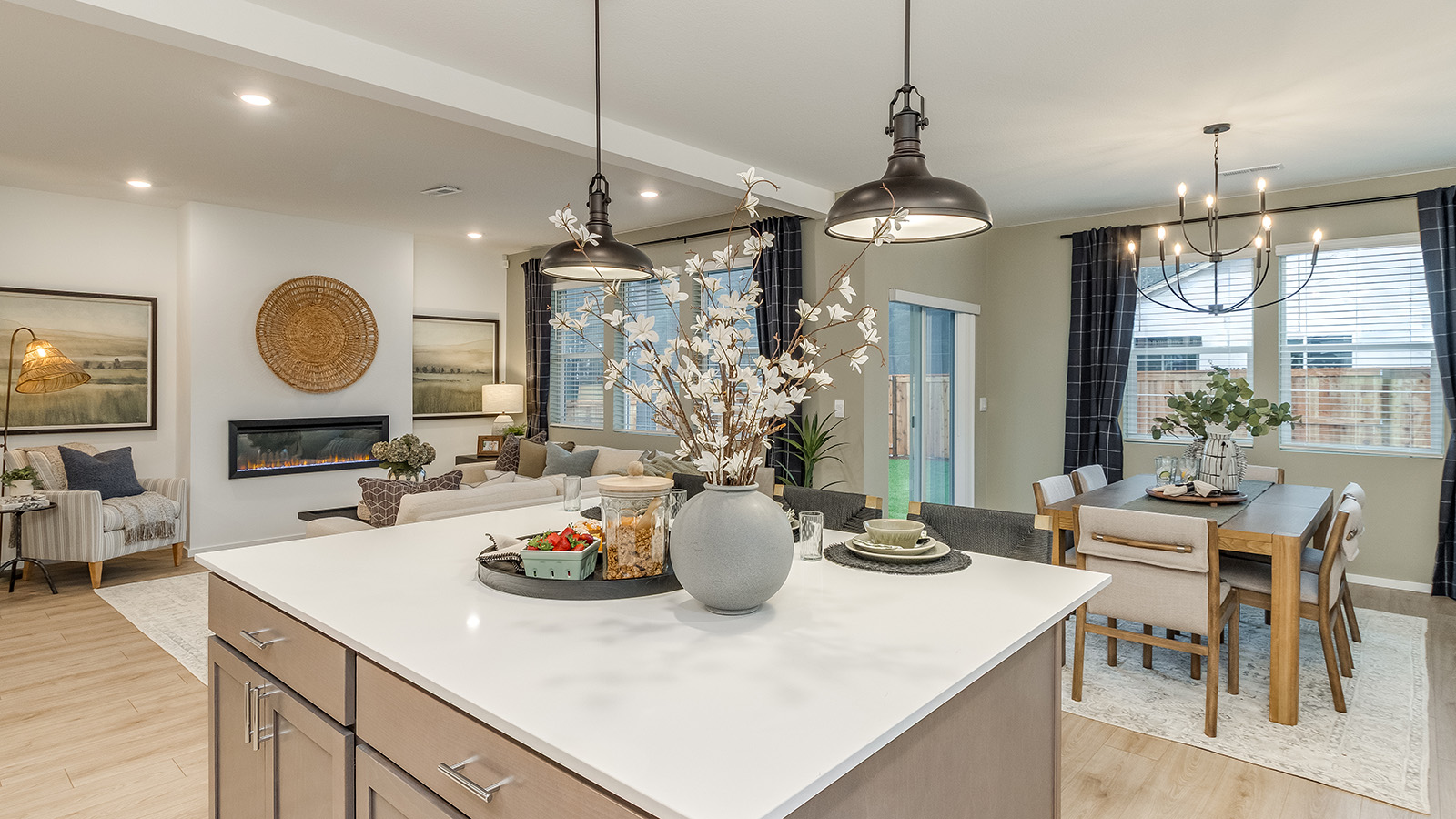 Kitchen with shaker cabinets, quartz counters, stainless steel appliances, pantry, and an island with a breakfast bar